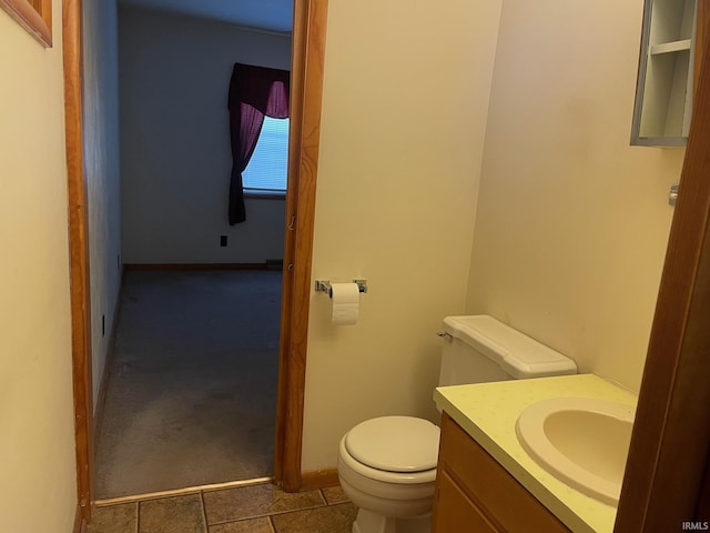 bathroom featuring vanity, toilet, and tile patterned flooring