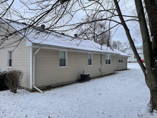 snow covered house with central AC