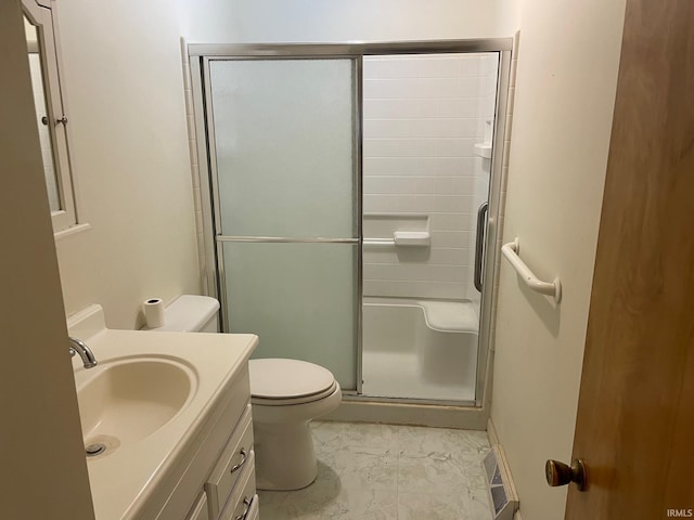 bathroom with toilet, an enclosed shower, and vanity