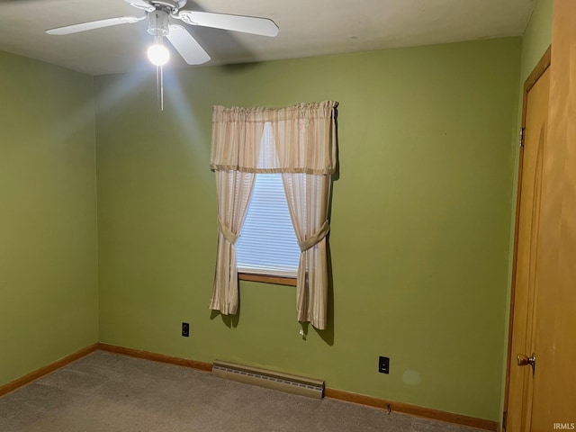 carpeted empty room with ceiling fan and a baseboard heating unit