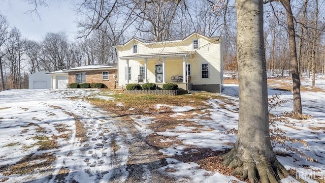 view of front of property with covered porch and a garage