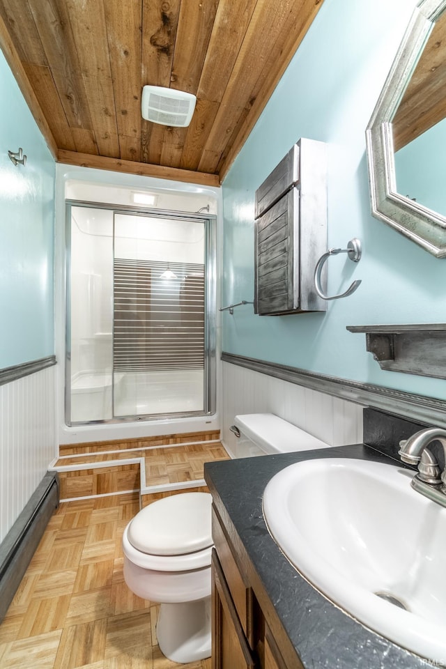 bathroom with wooden ceiling, vanity, wood walls, and parquet flooring