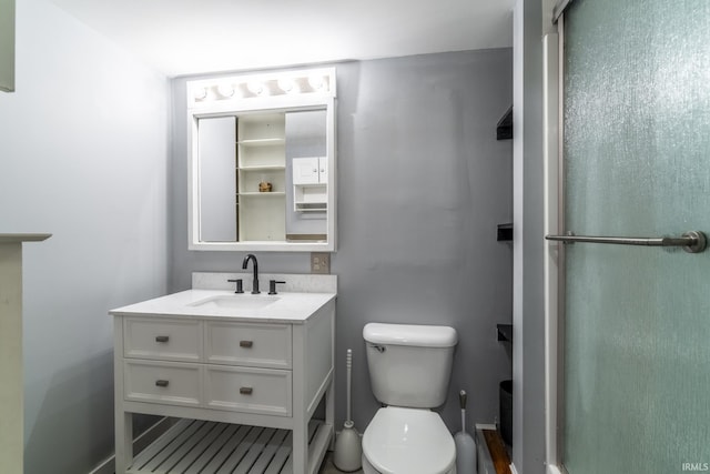 bathroom with toilet, vanity, and an enclosed shower