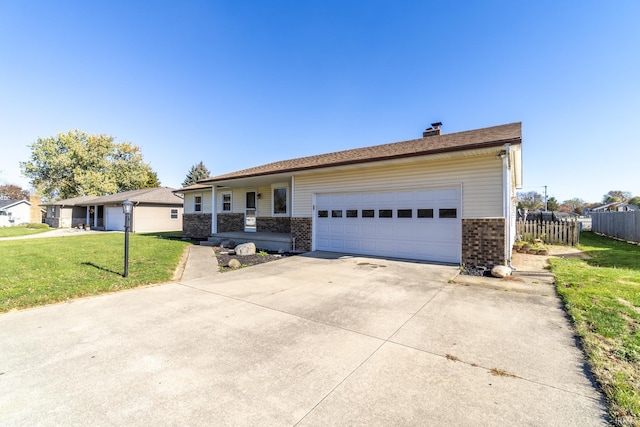 single story home with a garage and a front lawn