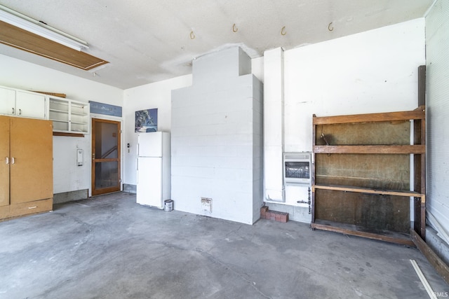 garage featuring white fridge