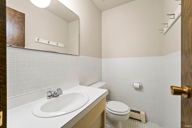 bathroom featuring toilet, a baseboard heating unit, tile walls, tile patterned flooring, and vanity