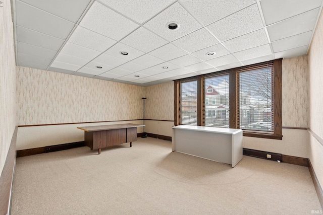 unfurnished office with light carpet and a drop ceiling