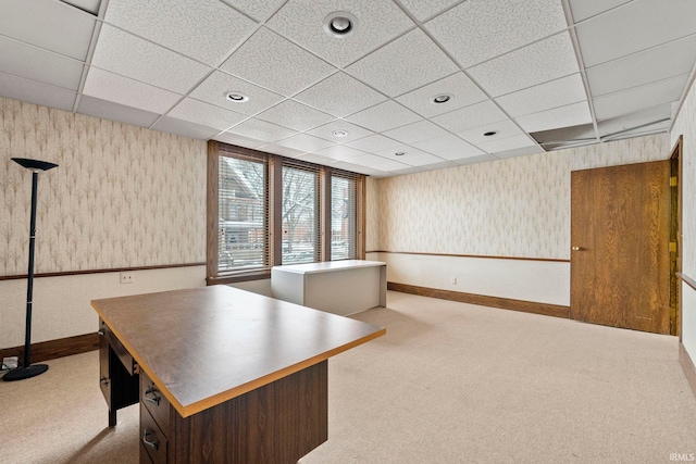 unfurnished office with a paneled ceiling and light colored carpet