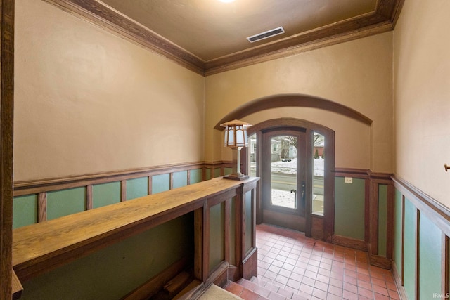 tiled entrance foyer with crown molding