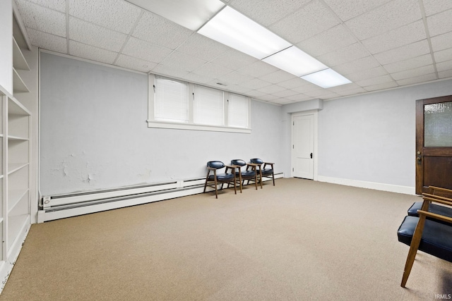 living area featuring a drop ceiling, carpet floors, and baseboard heating