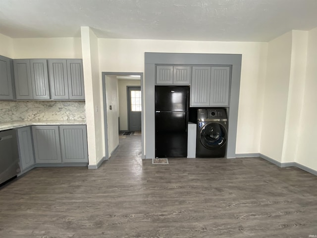 washroom featuring dark hardwood / wood-style flooring and washer / dryer