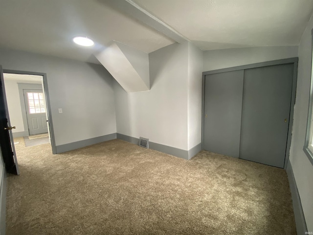 additional living space with light carpet and lofted ceiling