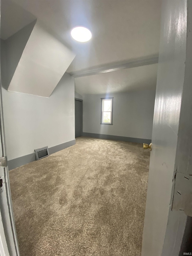 bonus room featuring carpet floors and vaulted ceiling