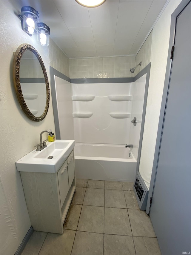 bathroom featuring vanity, tile patterned flooring, and tiled shower / bath combo