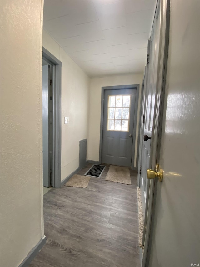 doorway to outside with dark wood-type flooring