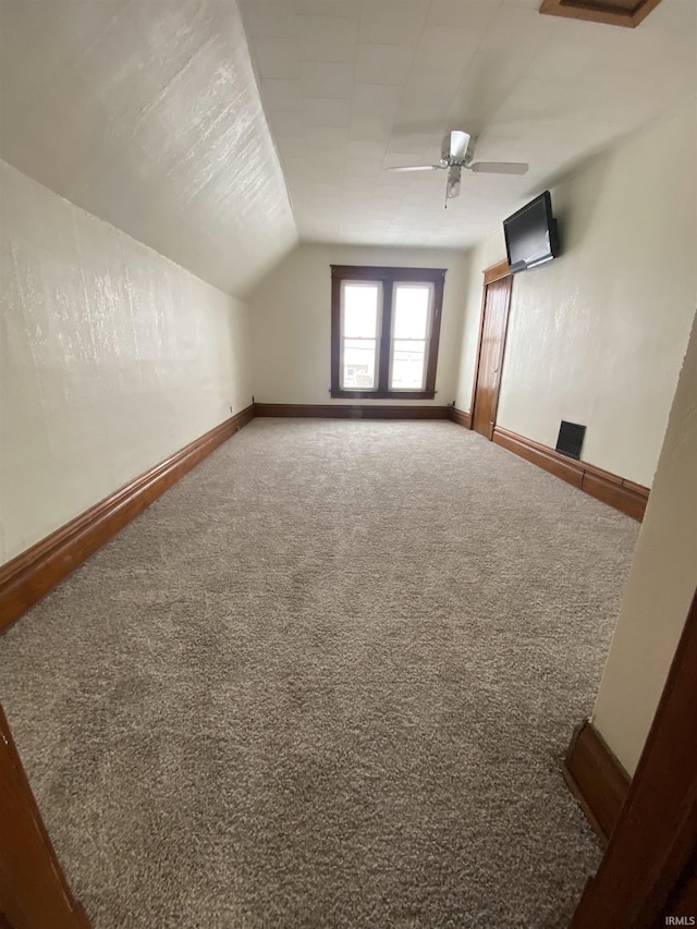 bonus room with vaulted ceiling, carpet, and ceiling fan