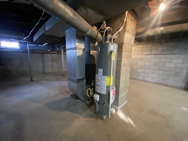 utility room featuring gas water heater and heating unit