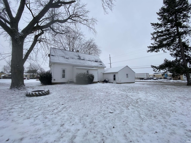 view of snow covered back of property