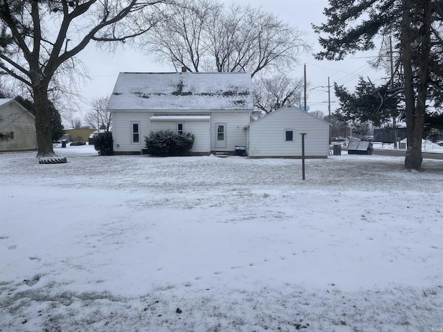 view of snow covered rear of property