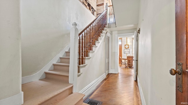 stairway with hardwood / wood-style flooring