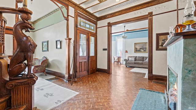 foyer entrance with crown molding and parquet floors