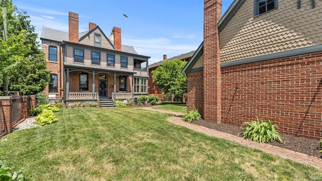 exterior space featuring covered porch and a lawn