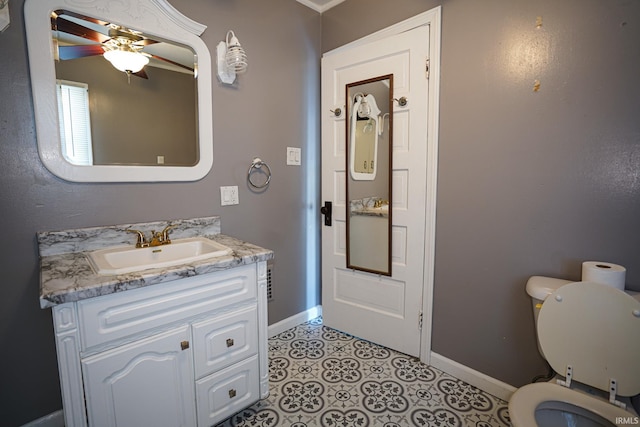 bathroom featuring toilet, tile patterned floors, ceiling fan, and vanity