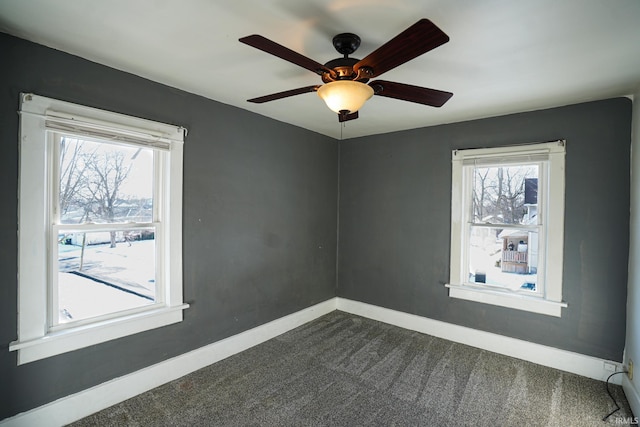 carpeted empty room featuring ceiling fan