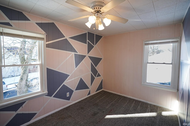 carpeted empty room featuring ceiling fan