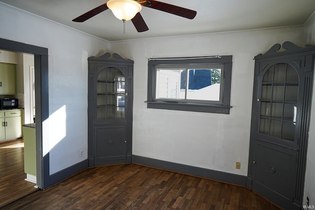 spare room with dark hardwood / wood-style flooring and crown molding