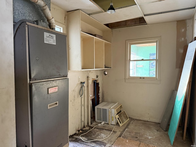 utility room featuring heating unit