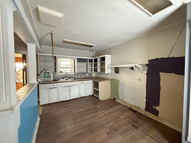 kitchen with sink, dark hardwood / wood-style flooring, white cabinets, and tasteful backsplash