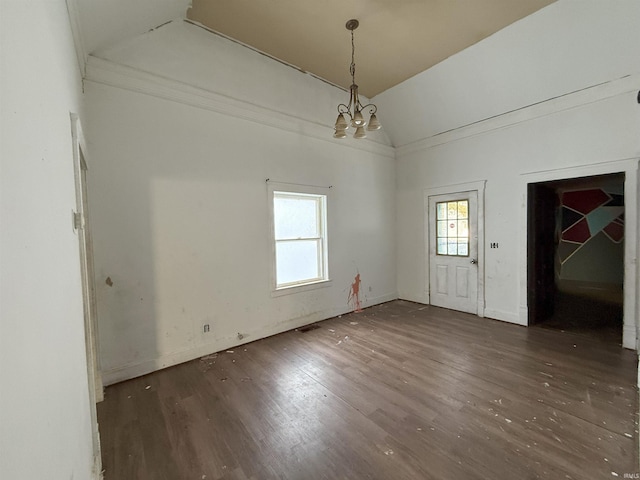 interior space with a chandelier, dark hardwood / wood-style flooring, and lofted ceiling