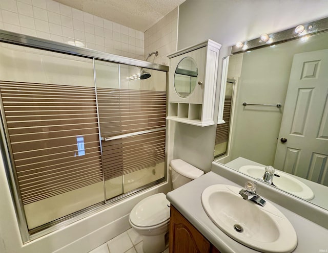 full bathroom featuring a textured ceiling, enclosed tub / shower combo, tile patterned flooring, vanity, and toilet