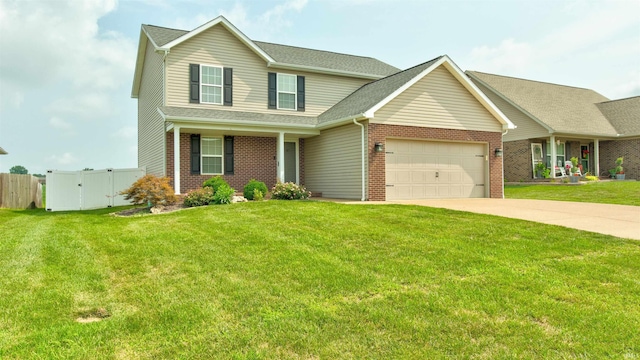 view of front of property featuring a garage, covered porch, and a front yard