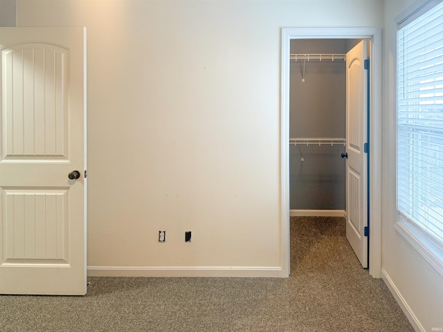 unfurnished bedroom with a closet and carpet flooring