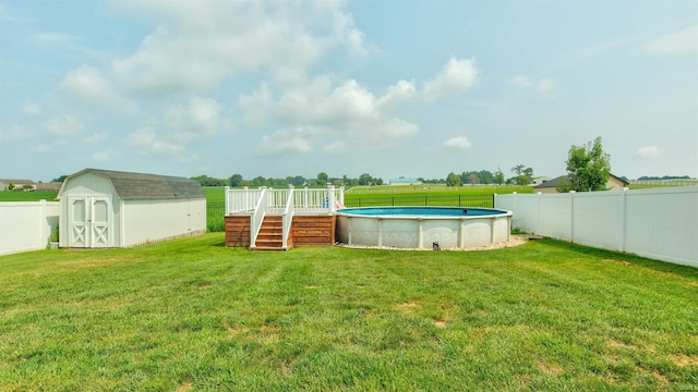 view of yard featuring a swimming pool side deck and a storage shed