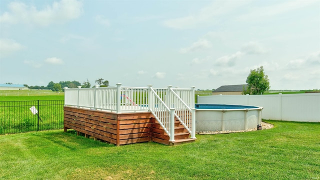 deck with a fenced in pool and a yard