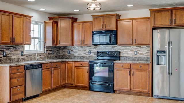 kitchen featuring black appliances, decorative backsplash, and sink