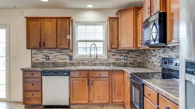 kitchen with decorative backsplash, sink, and black appliances