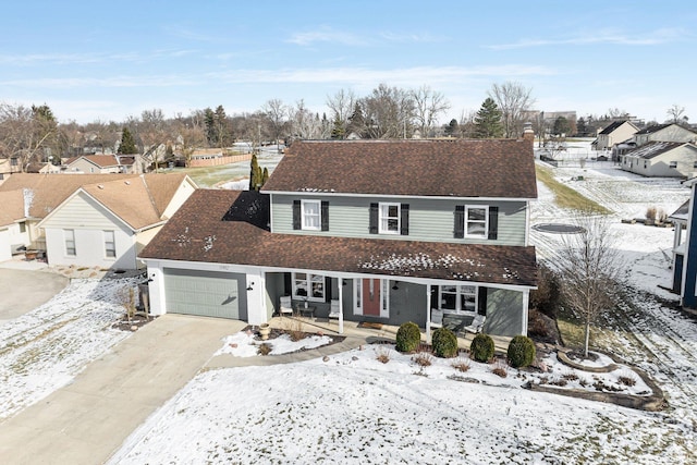 view of front property with a porch and a garage