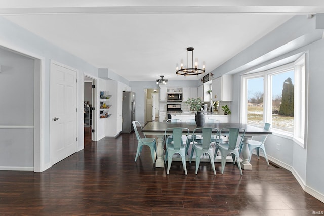 dining room featuring dark hardwood / wood-style flooring and an inviting chandelier