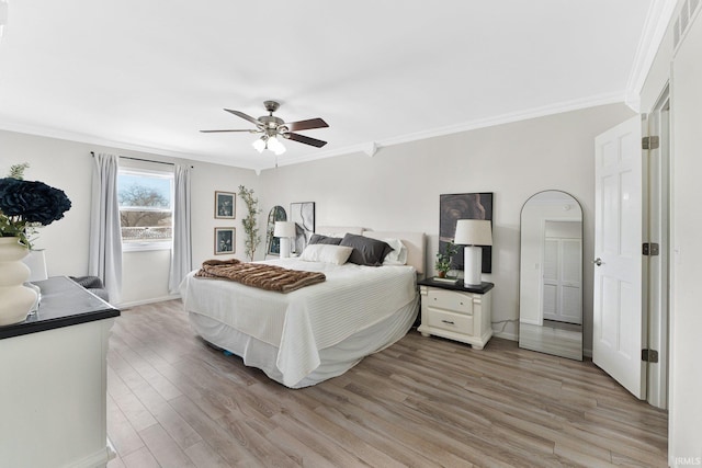 bedroom with light wood-type flooring, ceiling fan, and crown molding