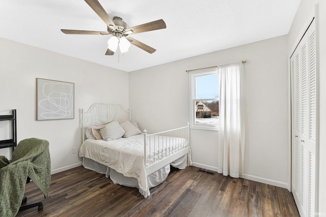 bedroom with a closet, ceiling fan, and dark hardwood / wood-style flooring