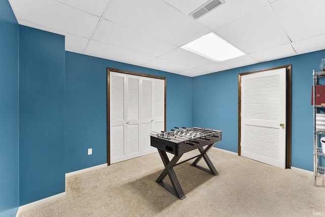 playroom with carpet flooring and a drop ceiling