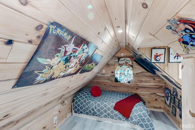 playroom with light hardwood / wood-style floors, wood walls, and wood ceiling