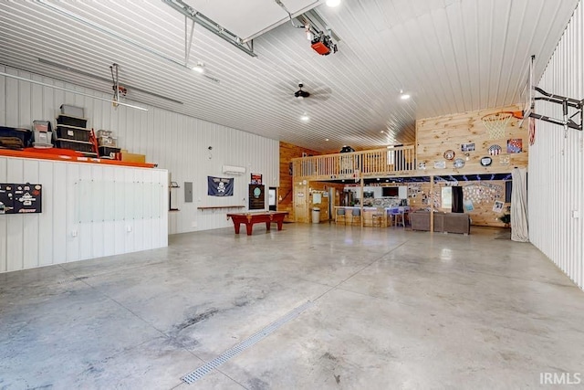 garage featuring wood walls and a garage door opener