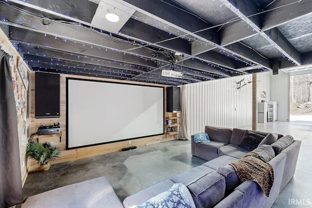 cinema featuring wood walls and concrete flooring