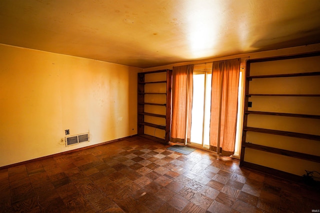 unfurnished room featuring dark parquet floors