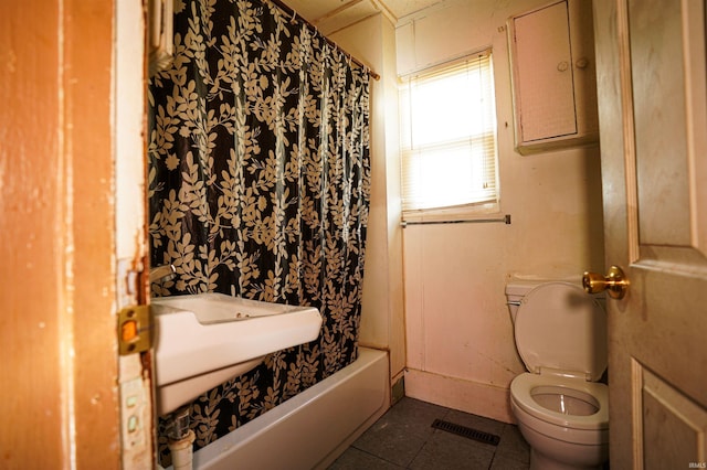 bathroom featuring toilet and tile patterned floors